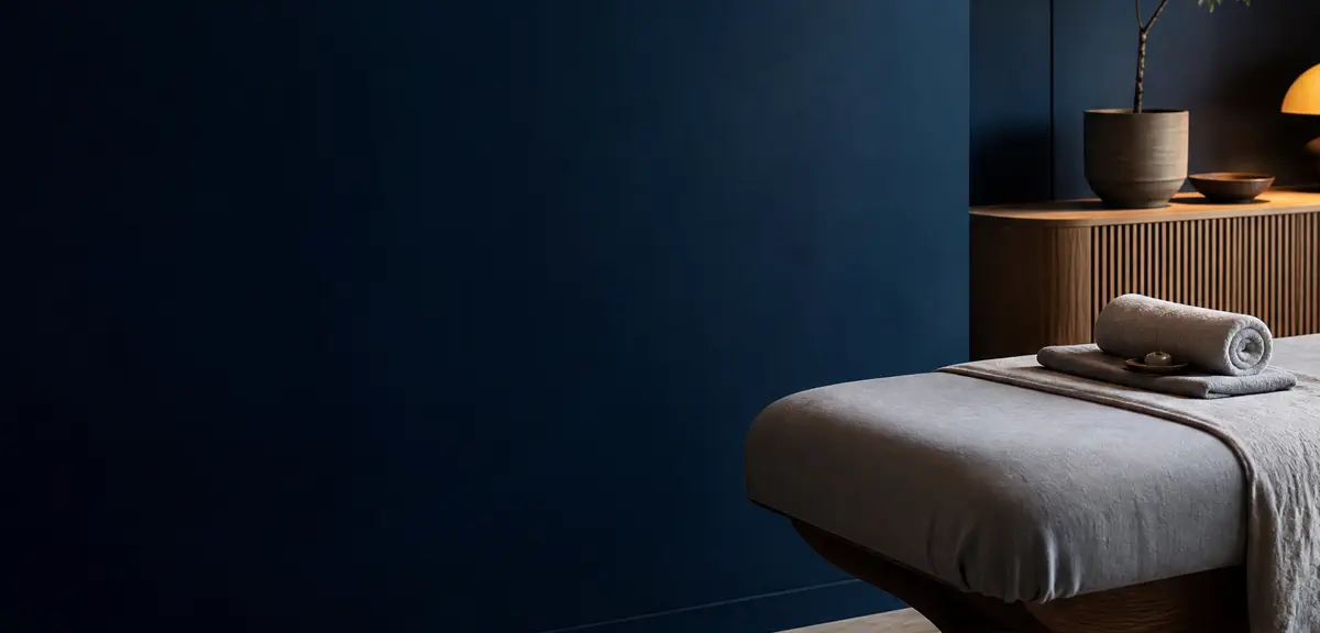 Warm stones and mineral blue towel in a calm wellness setting
